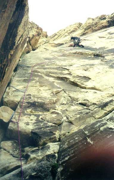 Looking up at a climber on pitch 6.