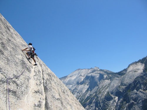 Chris McNamara on pitch 8 of Crest Jewel with Tenaya Canyon in the bac...