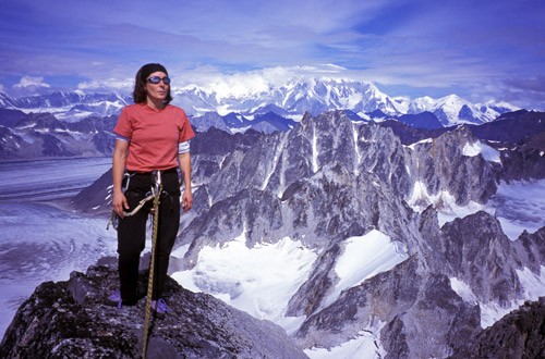 Michelle Puryear on the summit ridge of the Throne with Mt. Foraker in...
