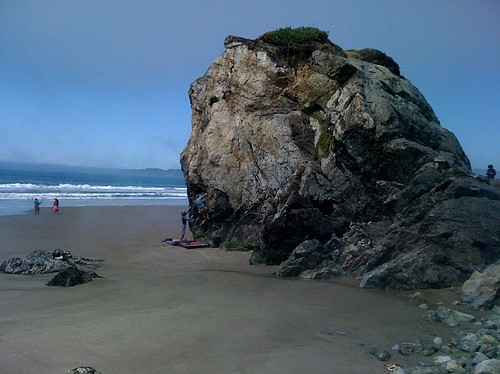 Climbers on The Old Man Boulder at Stinson Beach in April.