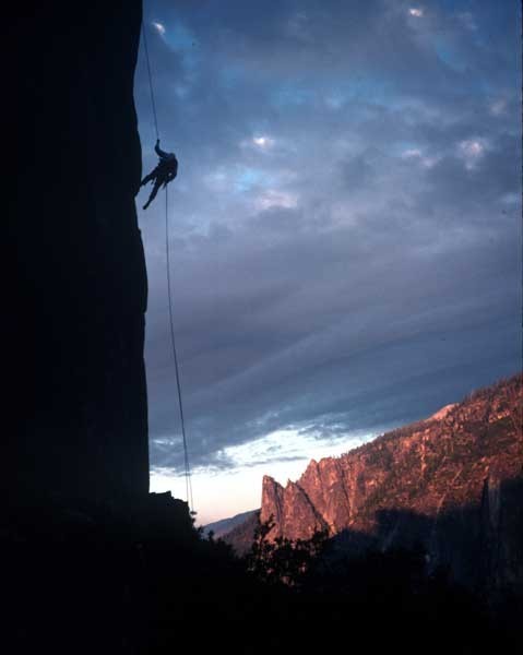 Tom Frost rappelling from Lower Cathedral Spire at sunset.