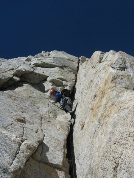 Eric Volz leading the first crux on pitch 4. Wide climbing at 13,000 f...