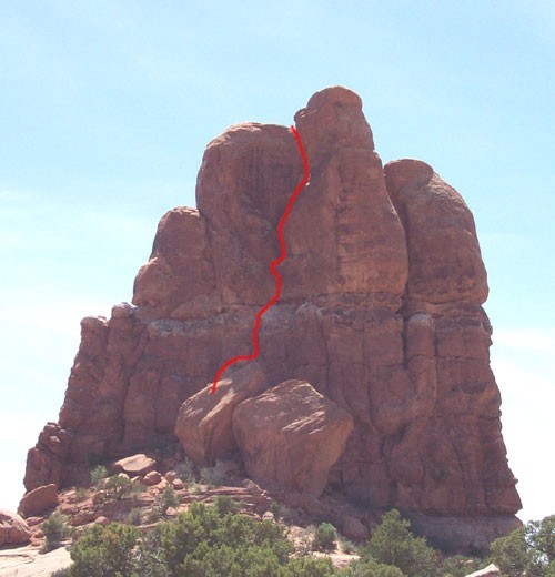 The route starts behind the boulders.