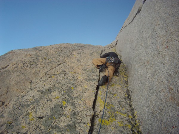 Charlie on the  classic triple crack corner, North buttress of Merriam...