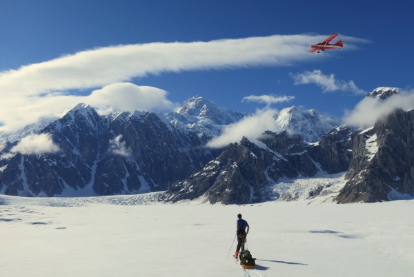 A plane of tourists flying through, with Denali in the background - wo...