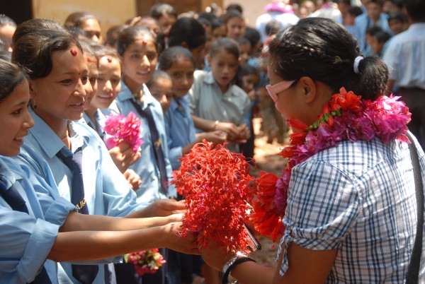 My wife receiving handmade flower leis at a school we brought chairs t...