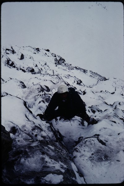 Charlie Pitts climbing the snowy ledges of the left side buttress.