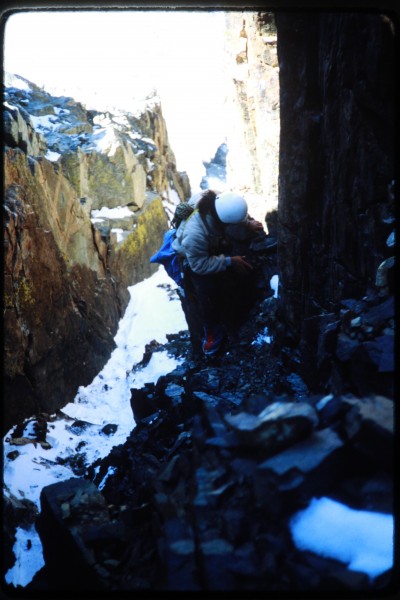 Jimmy scrambling up the rock near the top of the couloir.