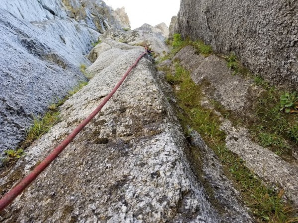 The chimney climbs the mossy grove on the right. EDIT: I'm now sure th...