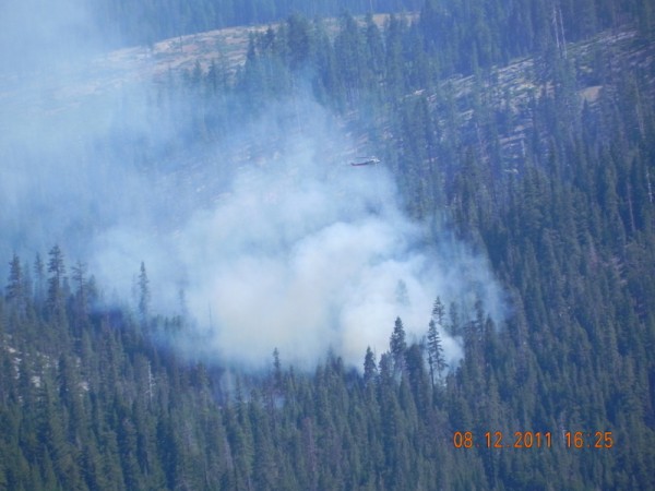 Heli dumps water on fire.