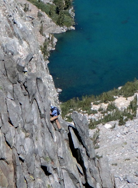 Soloist catching up to our elevation on Sun Ribbon Arete. 3rd Lake is ...